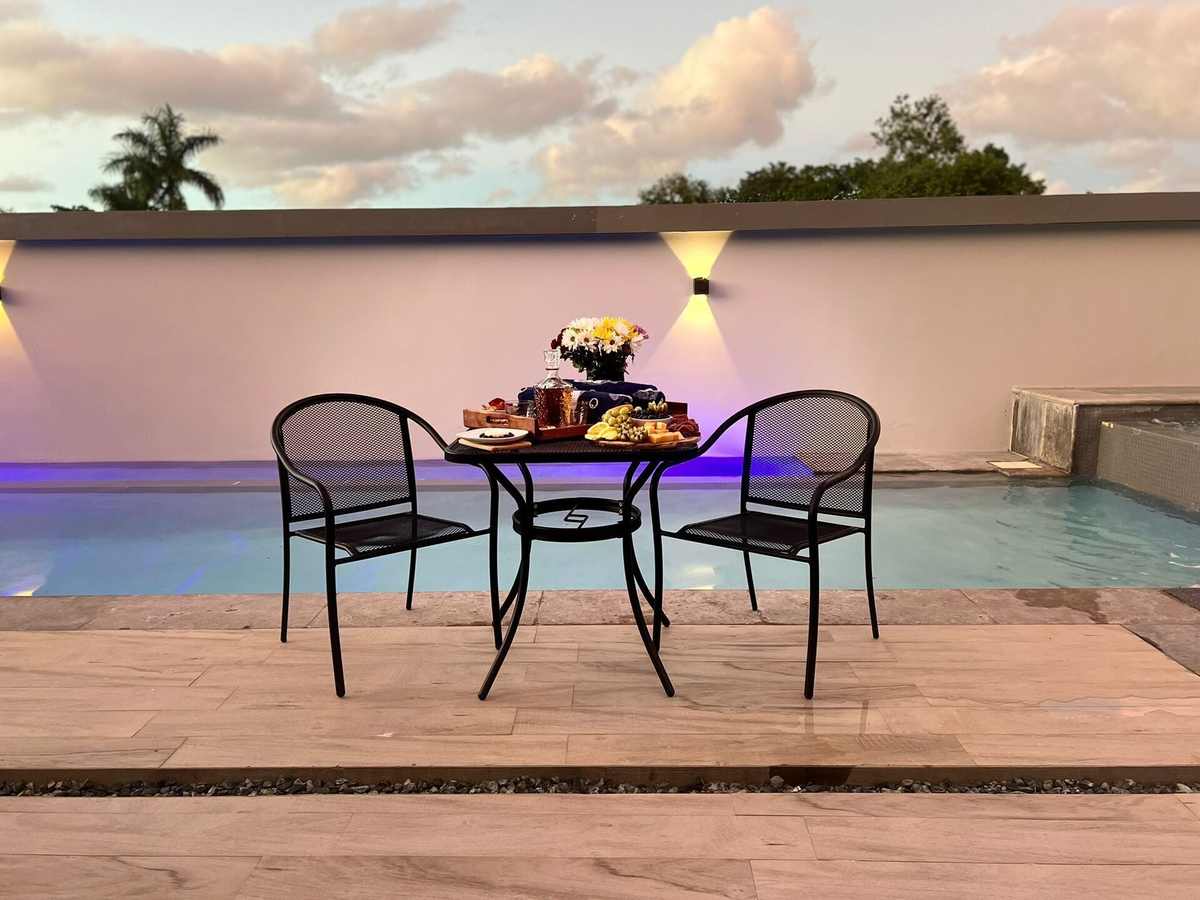 Table set for dinner on the terrace against a pastel sunset